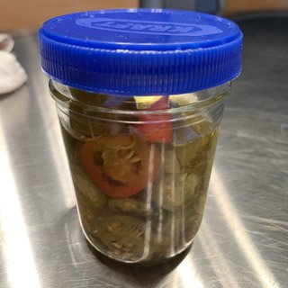 mason jar of jalapenos with mayo lid