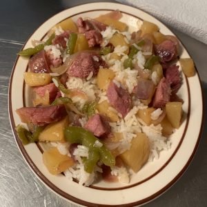 Plated pineapples and ham on rice